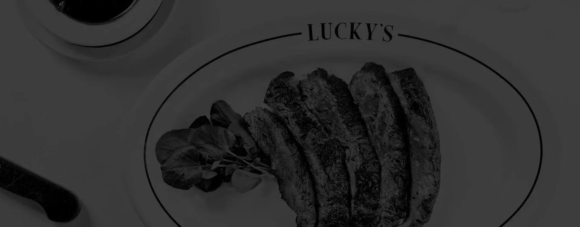 Interior dining table with steaks at Lucky's Steakhouse